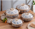 Four blue and white earthenware casserole pots with lids arranged on wooden surface, featuring leaf motifs and natural handle