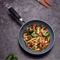 GraniteStone Fusion non-stick fry pan with sautéed shrimp and vegetables on gray textured surface, showcasing durability and 