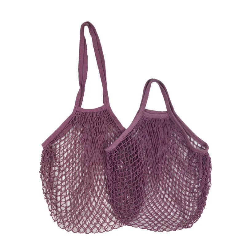Two purple cotton mesh produce bags with long handles, ideal for carrying vegetables and groceries plastic-free.