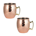 Pair of hammered copper insulated travel mugs with brass handles and stainless steel interiors, displayed against white backg