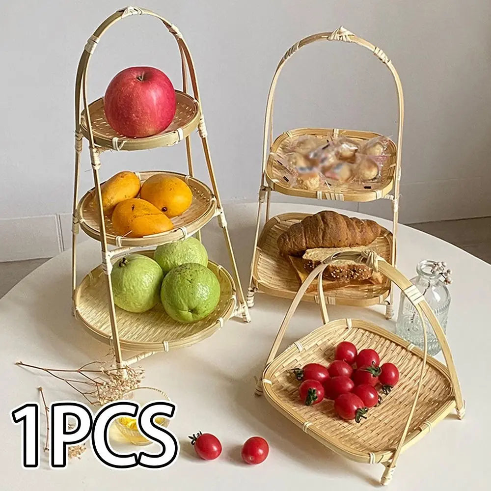 Miniature bamboo basket set with three tiers displaying fruits, bread, and vegetables on white surface, natural woven design