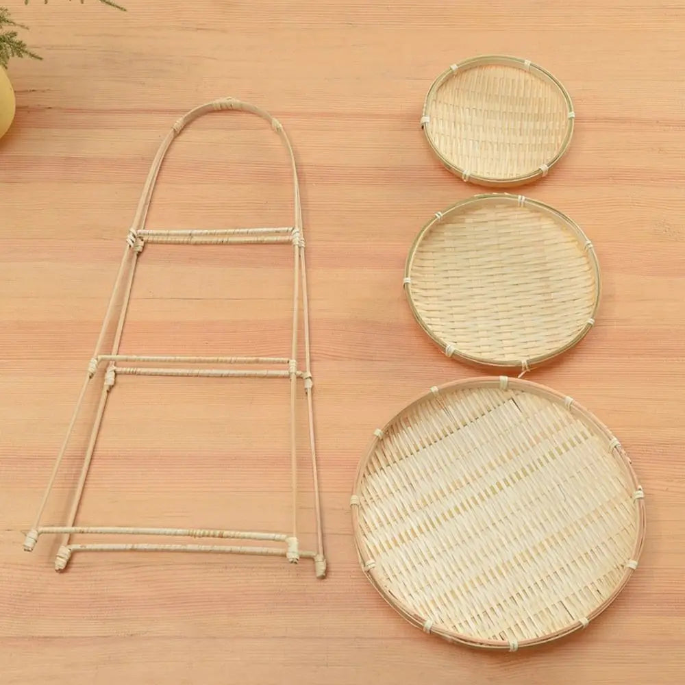 Miniature bamboo basket set with three round woven baskets and a tall narrow stand on wooden surface, natural pantry decor.