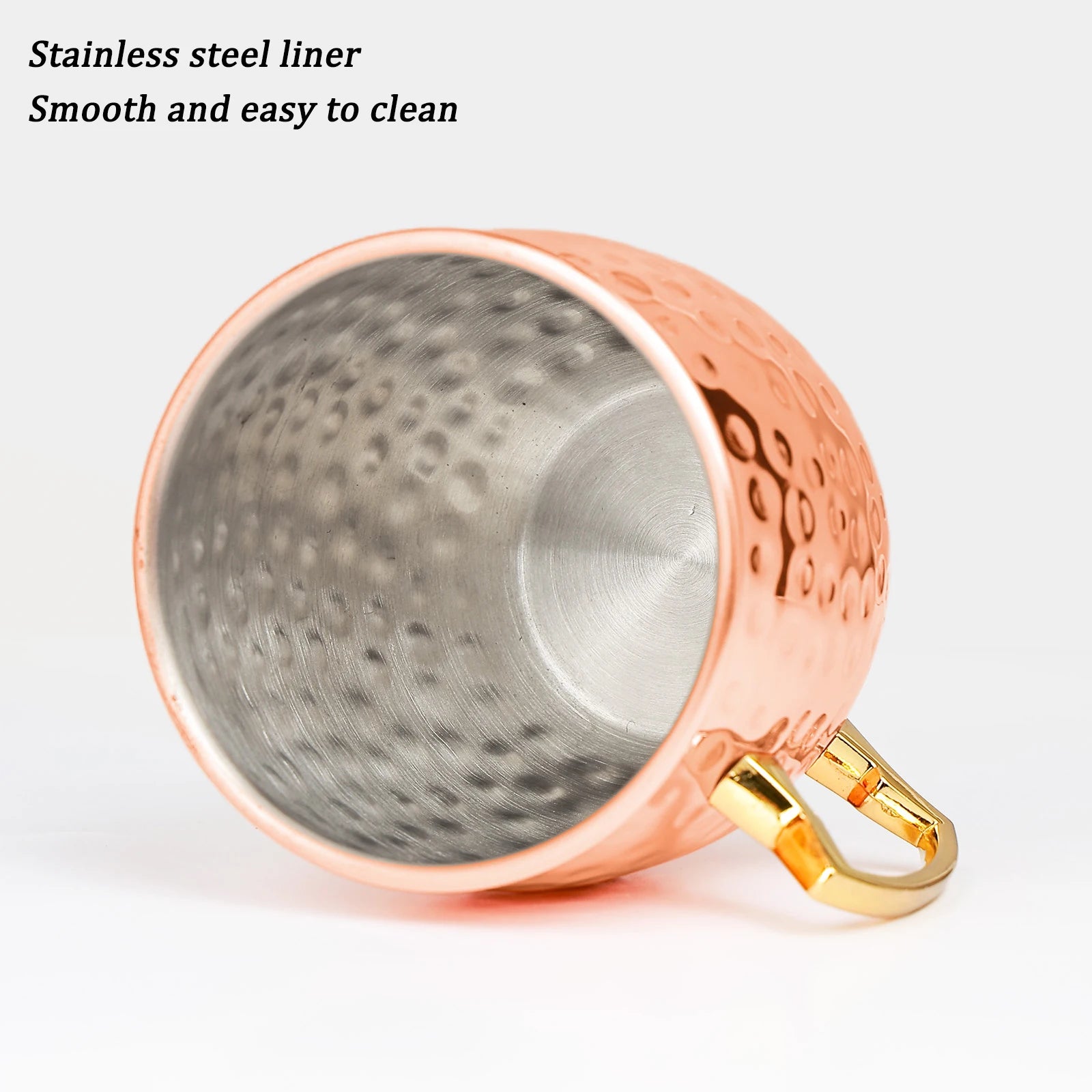 Insulated copper travel cup with hammered finish, stainless steel liner, and gold handles. Smooth interior for easy cleaning.