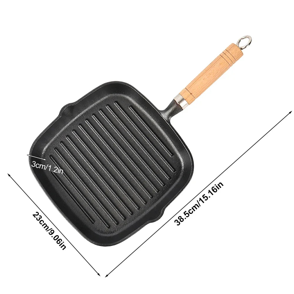 Cast iron square grill pan with ridged cooking surface, wooden handle, and drip spout. Dimensions shown: 23cm x 38.5cm.