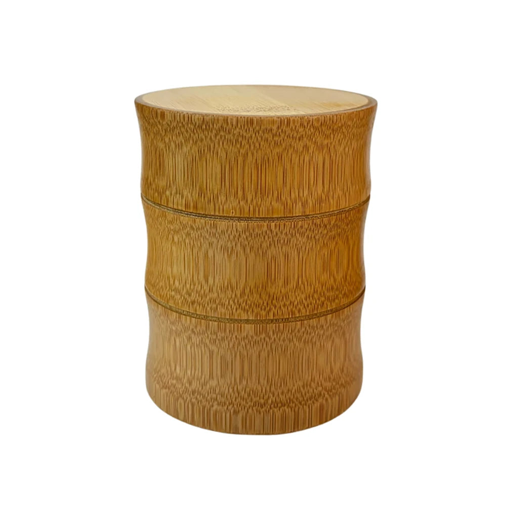 Bamboo food storage box with natural finish, cylindrical design, and metal bands dividing three compartments for tea, nuts, a