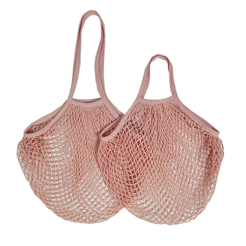 Two pink cotton mesh produce bags with long handles, displayed side by side, showing open weave construction for ventilation.