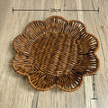 Hand-woven rattan bread basket with flower-shaped design, natural golden-brown weave, measuring 28cm wide by 4cm deep.