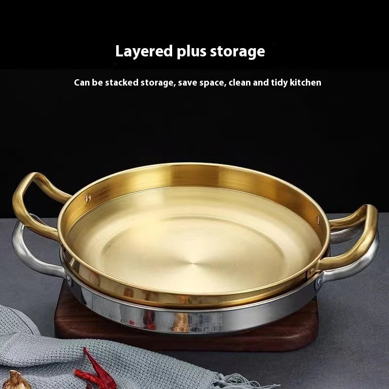 Golden stainless steel wok pan with dual brass handles on wooden base, featuring non-stick interior and layered storage desig