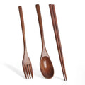 Wooden cutlery set with fork, spoon, and chopsticks on white background. Natural wood eco-friendly tableware.