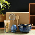 Japanese Matcha Bamboo Tea Set with ceramic blue bowls, bamboo whisk and spoon, stainless steel strainer, displayed with kraf