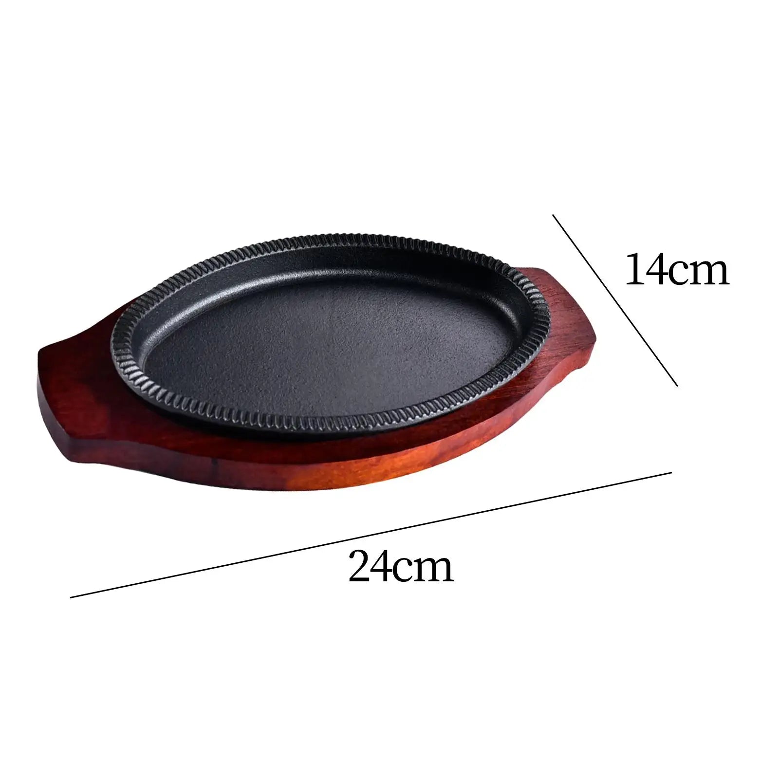 Cast iron oval griddle pan with decorative wooden serving board, 24cm x 14cm, dark metal cooking surface with textured rim.