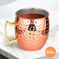 Copper insulated travel mug with hammered finish, gold handle, 500ml capacity, perfect for hot and cold beverages on the go.