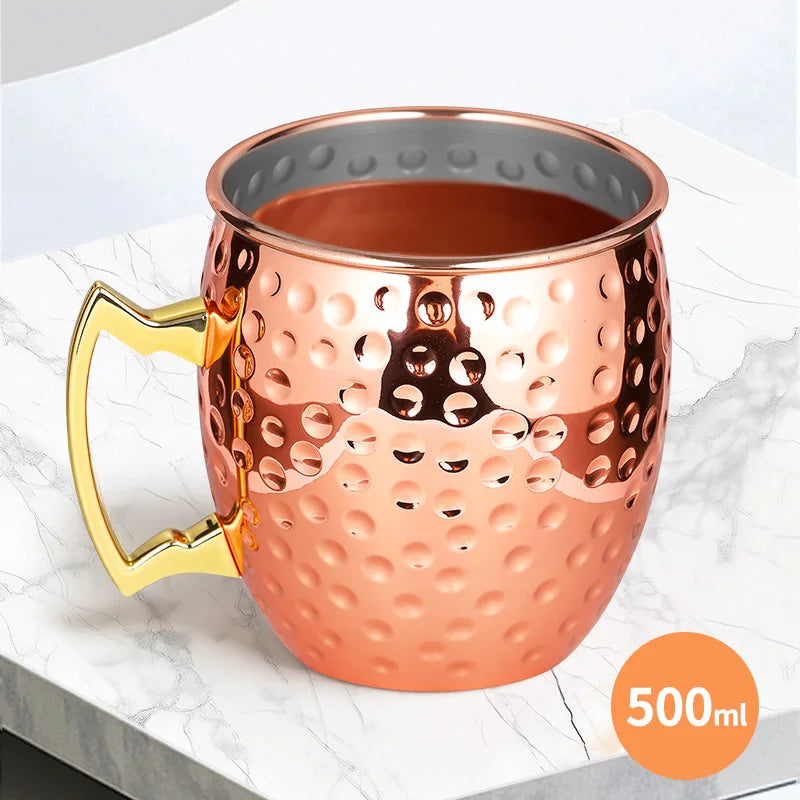Copper insulated travel mug with hammered finish, gold handle, 500ml capacity, perfect for hot and cold beverages on the go.