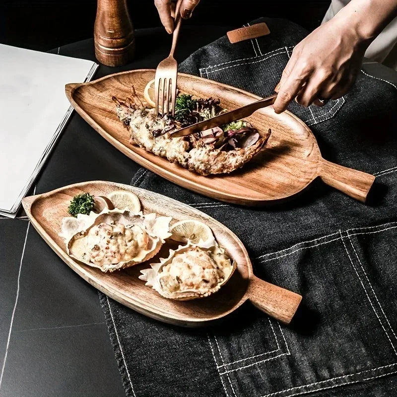 Wooden palm leaf-shaped sushi trays holding assorted sushi rolls with colorful toppings, displayed on dark surface with fork.