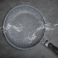GraniteStone Fusion nonstick fry pan with water beading on granite-coated surface, demonstrating superior nonstick performanc