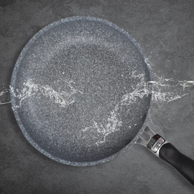 GraniteStone Fusion nonstick fry pan with water beading on granite-coated surface, demonstrating superior nonstick performanc
