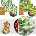 Beeswax food wraps in cactus and citrus prints covering bowls and produce, eco-friendly reusable cotton covers.
