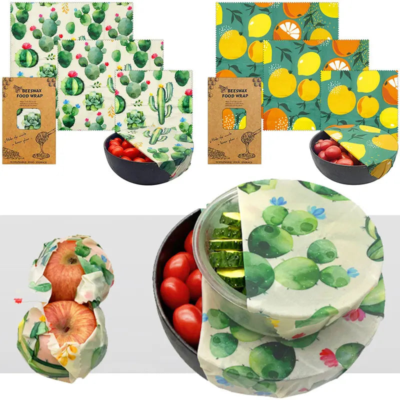 Beeswax food wraps in cactus and citrus prints covering bowls and produce, eco-friendly reusable cotton covers.