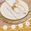 Handwoven rattan round placemat with elegant place setting, gold-rimmed white plate, gold flatware, and white napkin with gol