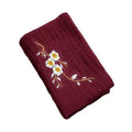 Burgundy organic cotton cleaning cloth with embroidered white daisies and golden stems, absorbent and eco-friendly kitchen to
