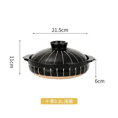 Black earthenware clay casserole pot with lid, 21.5cm wide, 0.8L capacity, featuring ribbed design for slow cooking soups and