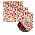 Beeswax food wrap set with strawberry pattern, featuring reusable organic cotton covers and sustainable food storage packagin