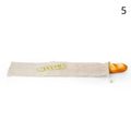 Handmade organic linen bread bag with wooden handle, featuring embroidered baguette design for eco-friendly loaf storage.