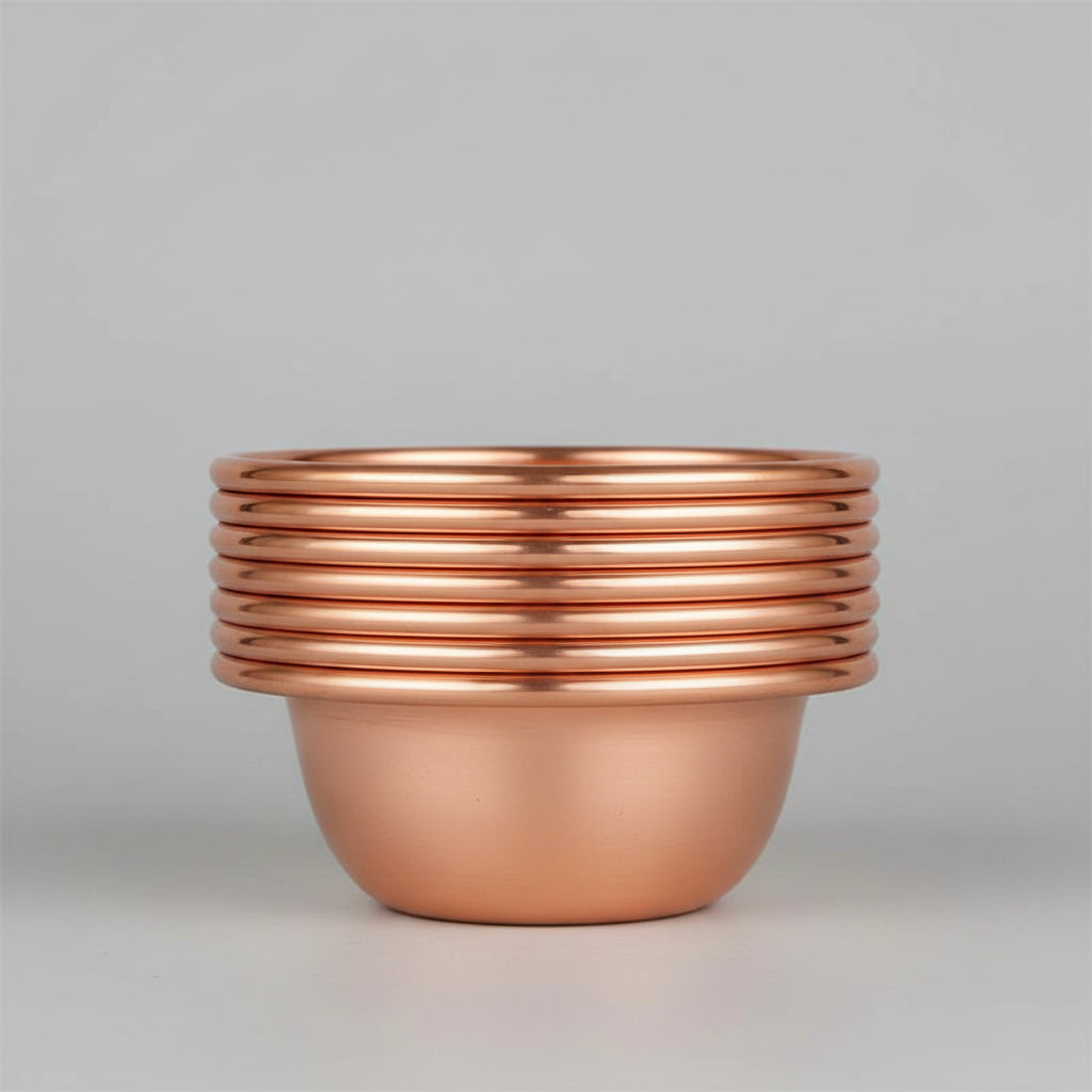 Pure copper dining bowl with ribbed rim detail, showcasing warm metallic finish against dark background for eco-friendly kitc