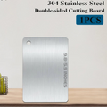 304 Stainless Steel double-sided cutting board with slip-resistant surface, displayed on wooden countertop.