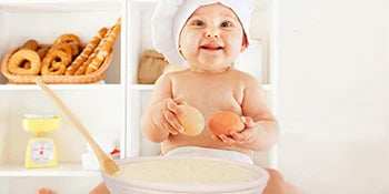 Natural rattan bread proofing basket with handmade banneton design, displayed with baby and baking ingredients on eco-friendl