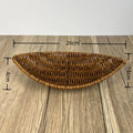 Hand-woven rattan bread basket with natural golden-brown finish, measuring 28cm wide by 14cm deep, displayed on wooden surfac