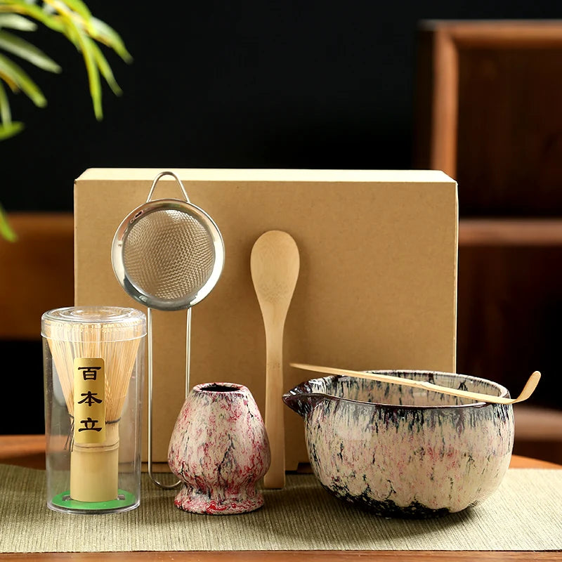 Japanese Matcha Tea Set with bamboo whisk, wooden spoon, ceramic bowl, strainer, and brush in eco-friendly packaging on neutr