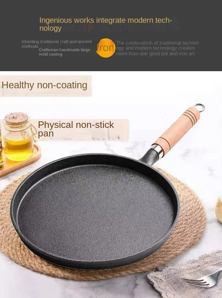 Black cast iron skillet with wooden handle on marble surface, surrounded by oil and kitchen linens, showcasing non-stick cook