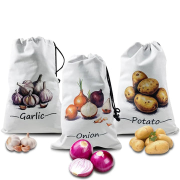 Three white canvas drawstring bags labeled Garlic, Onion, and Potato with illustrated vegetables and fresh produce displayed 