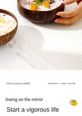 Coconut shell dessert bowls filled with creamy pudding and fresh fruit toppings, held in hands over white surface.