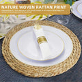 Handwoven round rattan placemat with natural woven texture, featuring white plate with gold trim and rolled napkin on dark ta