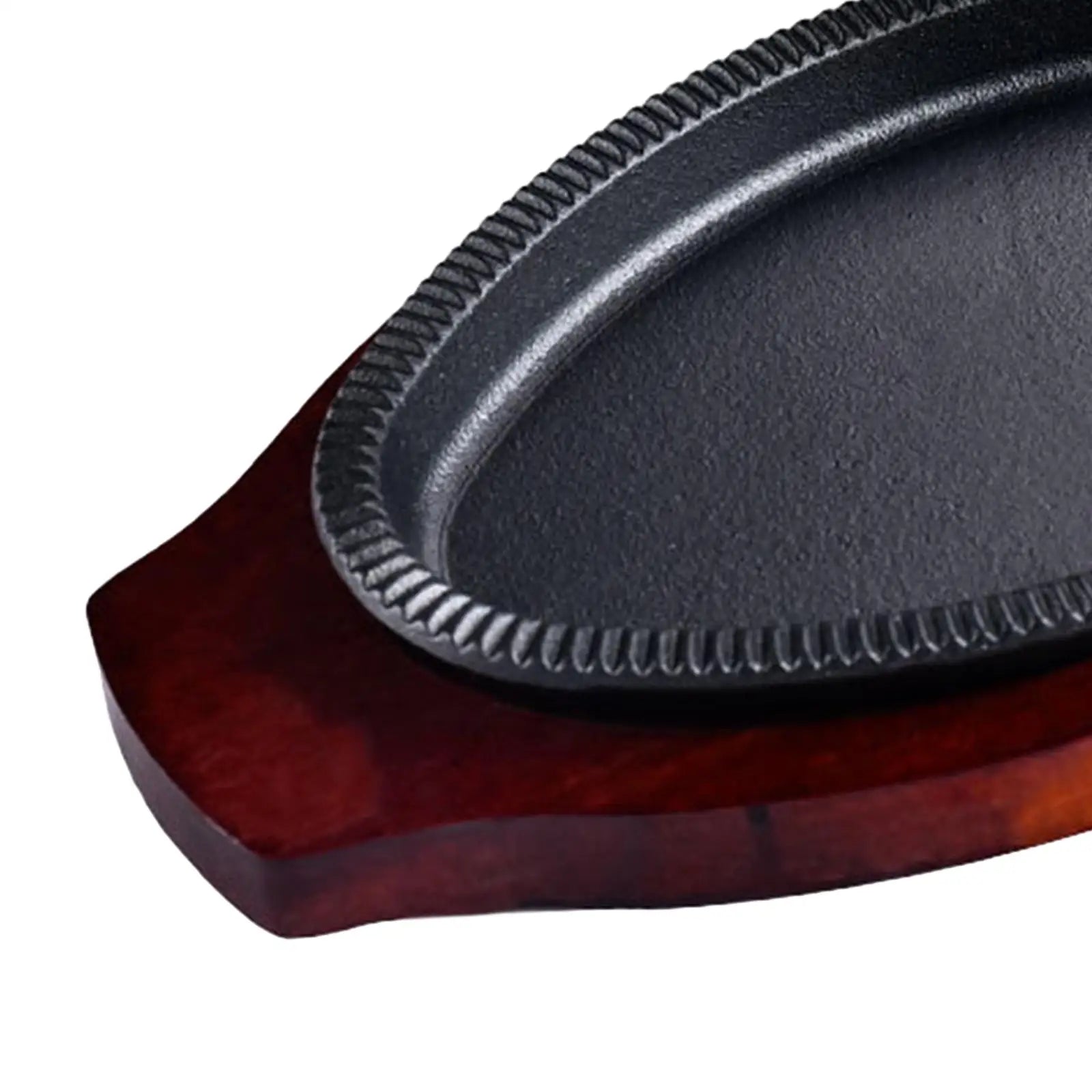 Cast iron griddle pan with ribbed cooking surface and included wooden serving board in dark wood finish