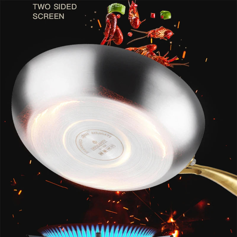 Stainless steel wok pan with golden handle on gas flame, showing two-sided non-stick screen, surrounded by fresh red chilies 