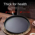 Cast iron egg skillet with thick base on woven placemat, featuring high temperature technology and energy-efficient design fo
