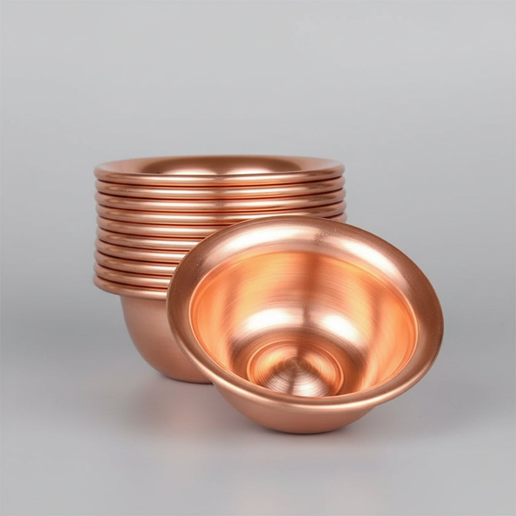 Pure copper dining bowl set with stacked bowls showing polished interior finish and hammered texture on wooden surface.