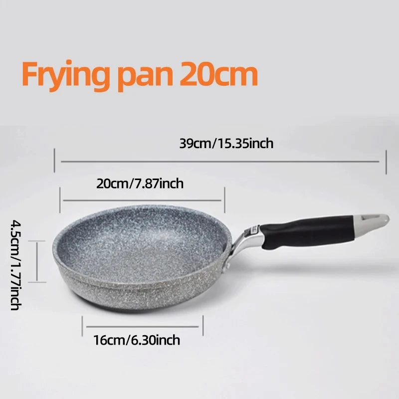 GraniteStone Fusion fry pan with gray granite non-stick coating, black handle, displayed on striped kitchen towel with decora