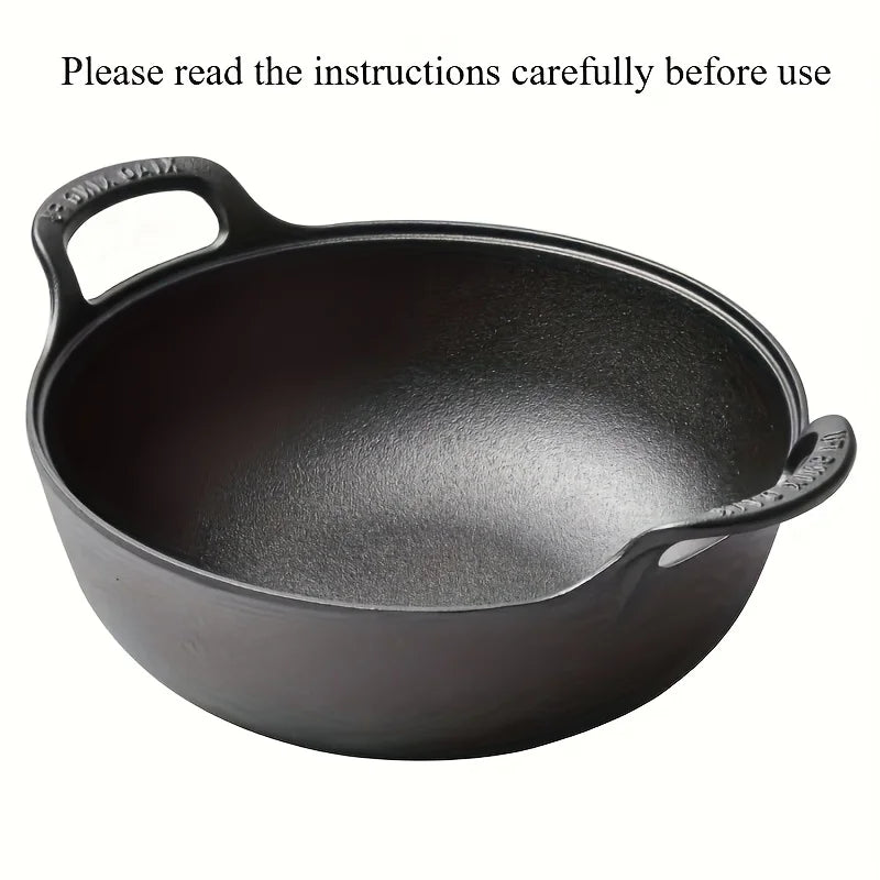 Black cast iron double-handle pot with curved sides and textured handles, displayed against white background.
