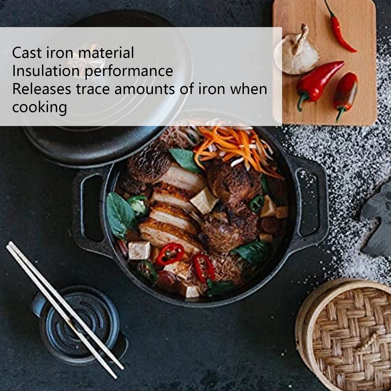 Cast iron Dutch oven pot with lid containing cooked meat and vegetables, surrounded by fresh ingredients and cooking utensils
