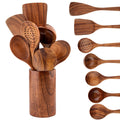 Wooden kitchen utensil set with spatulas, spoons, and forks displayed in a cylindrical holder, showing natural wood grain det