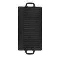 Black cast iron dual-sided griddle with ridged grill surface and handles, ideal for indoor and outdoor cooking.