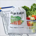 White insulated reusable vegetable bag with handles filled with fresh broccoli, lettuce, carrots, tomatoes, and cauliflower i
