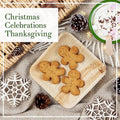 Eco-friendly palm leaf plates displaying gingerbread cookies, pinecones, and festive decorations on natural linen background.