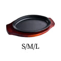 Cast iron fajita griddle pan with decorative rope rim on dark wood serving board, available in small, medium, and large sizes