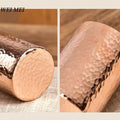 Handcrafted pure copper mug with hammered texture detail, showing smooth interior and textured exterior surface.
