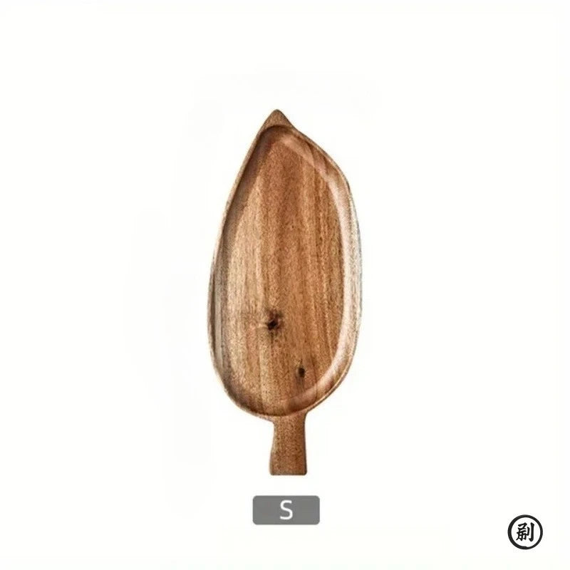 Natural wooden palm leaf-shaped dessert tray, handcrafted from sustainable wood with organic curves and stem handle, size S.